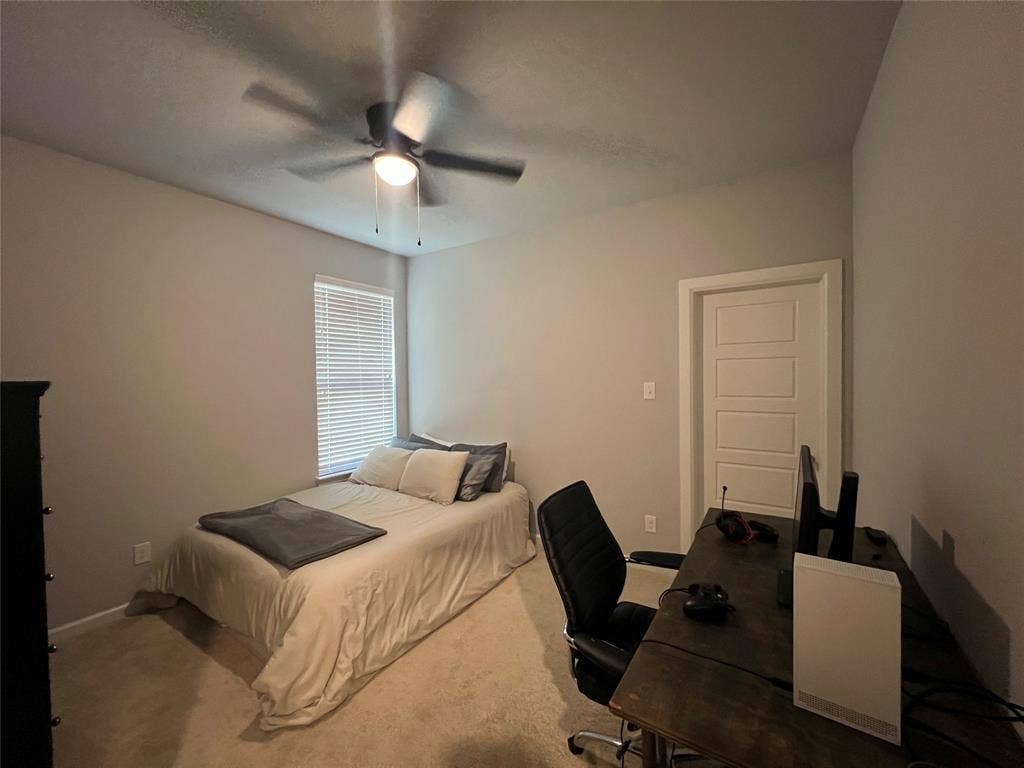 3210 Mattie Grey Lane, Melissa, TX 75454 Carpeted bedroom featuring an office area and a ceiling fan