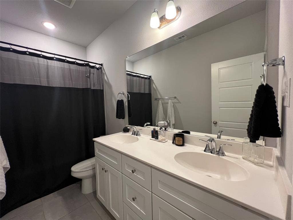 3210 Mattie Grey Lane, Melissa, TX 75454 Bathroom with double vanity, tile patterned floors, and a shower with curtain