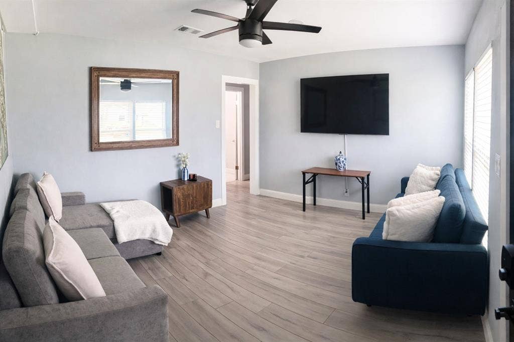 228 Harrison Lane, Hurst, TX 76053 Light wood-finish flooring throughout, ceiling fan with integrated lighting, and white trim
