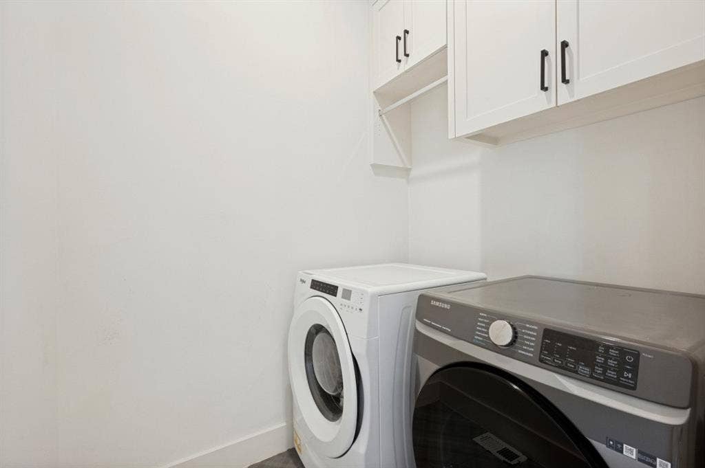 White shaker-style cabinetry with matte black hardware