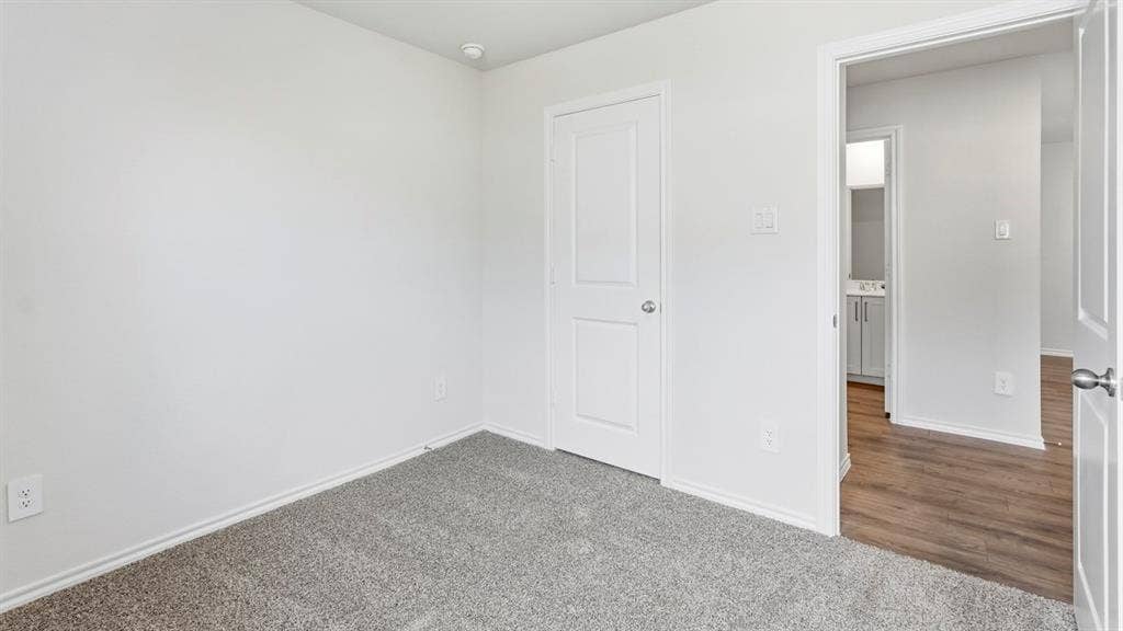 3327 Twilight Trail, Talty, TX 75126 Neutral tone walls, grey carpet flooring, white trim, recessed lighting, and a white interior door