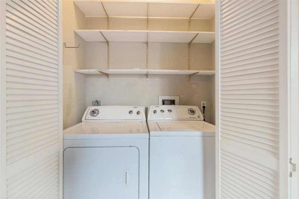 9400 Doliver Drive, #59, Houston, TX 77063 Louvered bifold doors opening to a laundry area with upper shelving