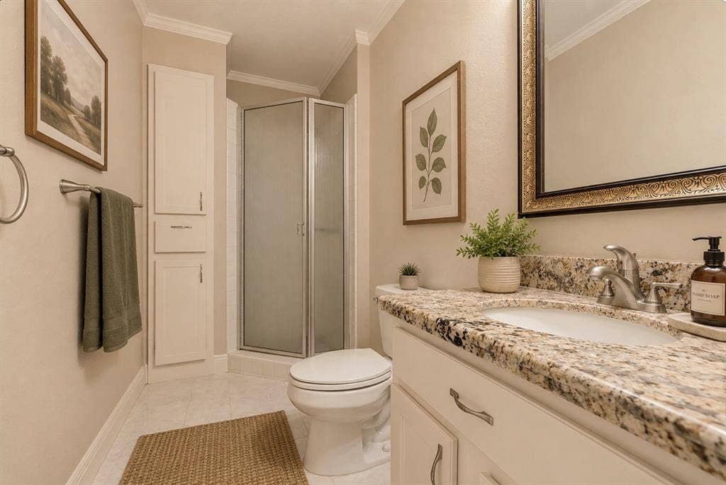 9400 Doliver Drive, #59, Houston, TX 77063 Built-in vanity with a granite-style countertop, undermount sink, and brushed nickel faucet