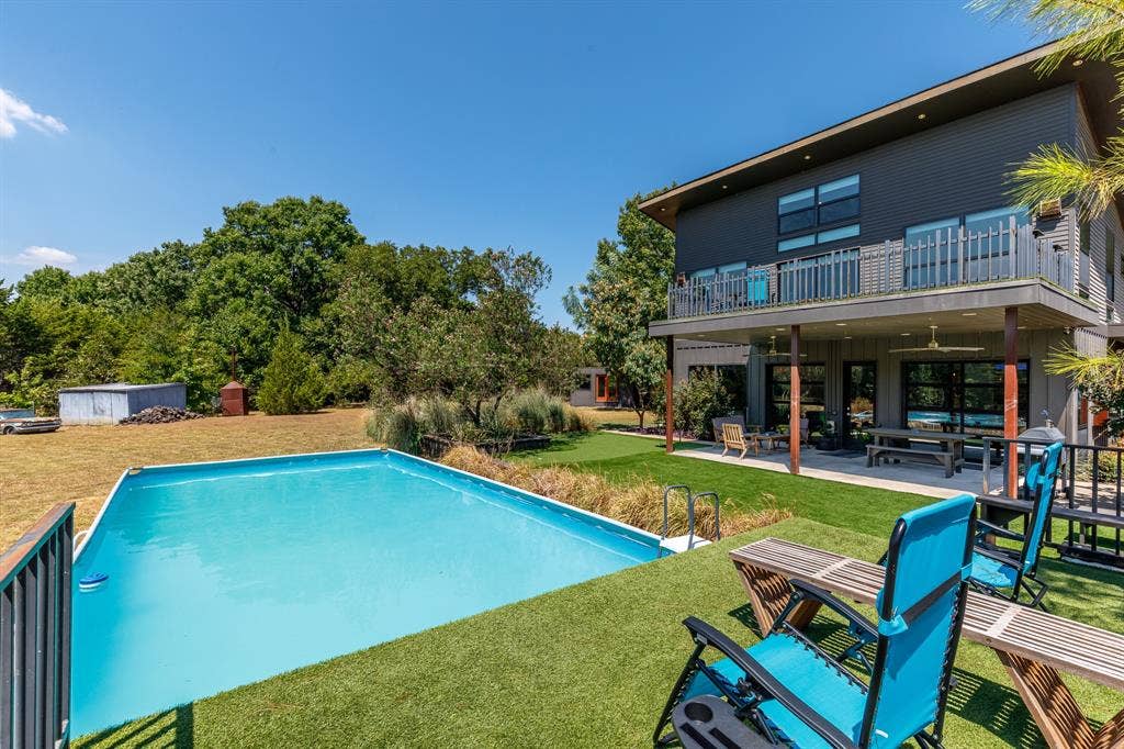6448 County Road 437, Princeton, TX 75407 Contemporary exterior with a rectangular pool, covered patio, upper balcony, and a flat roofline