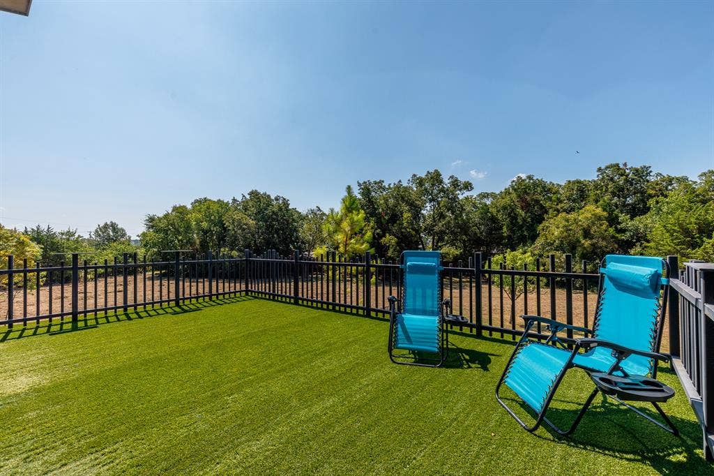 6448 County Road 437, Princeton, TX 75407 Outdoor deck with artificial turf and black metal fencing