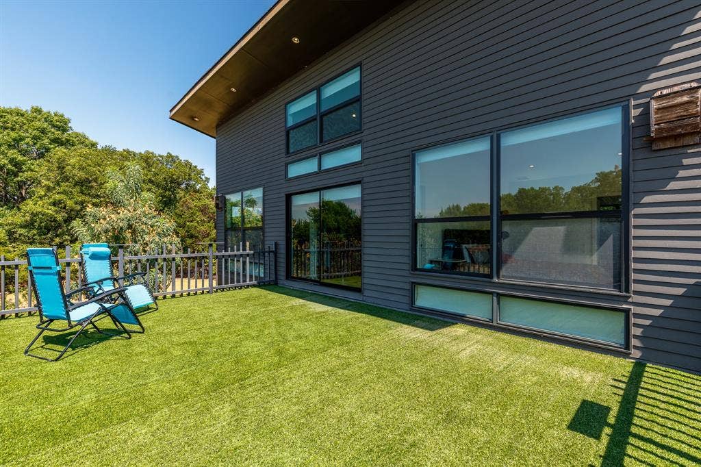 6448 County Road 437, Princeton, TX 75407 Expansive outdoor deck featuring artificial turf, a white picket fence, and dark siding