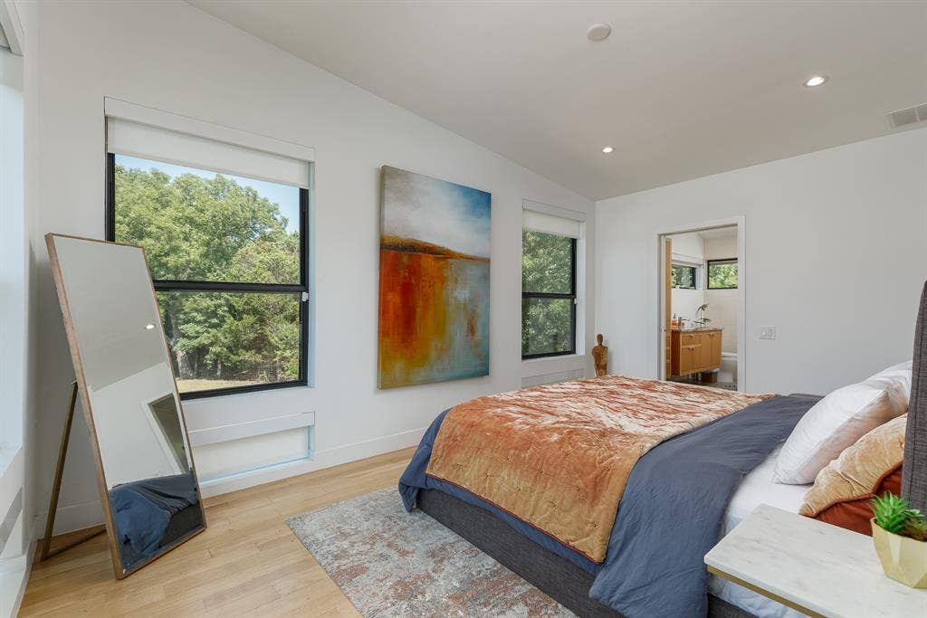 6448 County Road 437, Princeton, TX 75407 Recessed ceiling lighting, wood-finish flooring, two large windows, white walls, and a visible doorway leading to an additional space