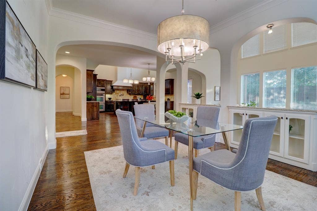 11559 Ashley Lane, Frisco, TX 75035 Hardwood flooring, arched doorways, built-in cabinetry with glass inserts, chandelier, and transom windows