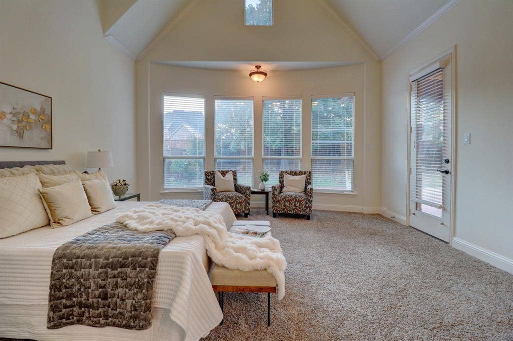 11559 Ashley Lane, Frisco, TX 75035 Vaulted ceiling with an upper window, bay window with multiple panes, ceiling-mounted light fixture, and a glass-paneled door