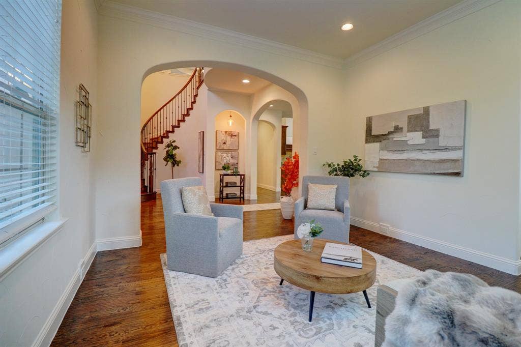 11559 Ashley Lane, Frisco, TX 75035 Hardwood-finish flooring, recessed lighting, arched doorways, crown molding, and a visible curved staircase