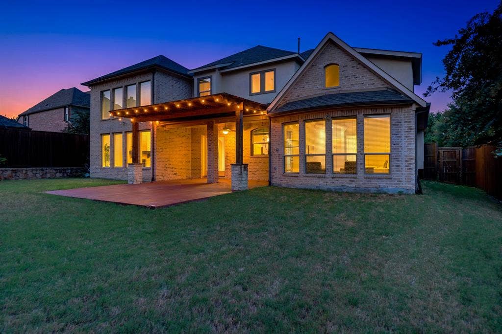 11559 Ashley Lane, Frisco, TX 75035 Expansive backyard featuring a manicured lawn, an outdoor patio, and a covered pergola