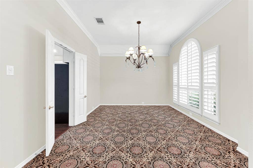 3217 Royal Melbourne Drive, Plano, TX 75093 An elegant chandelier, arched window with plantation shutters, and patterned carpet frame this formal dining room, complete with direct kitchen access. It provides the perfect backdrop for hosting holiday feasts or gathering loved ones for unforgettable dinners