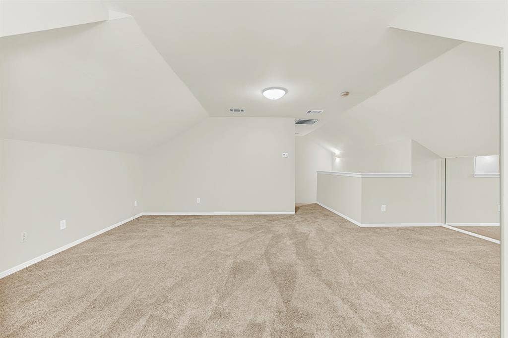 3217 Royal Melbourne Drive, Plano, TX 75093 Looking toward the staircase landing, this photo demonstrates the private, secluded feel of having a standalone room occupying the entire upper level. It provides a peaceful retreat for hosting movie nights, pursuing hobbies, or relaxing in your own quiet sanctuary.