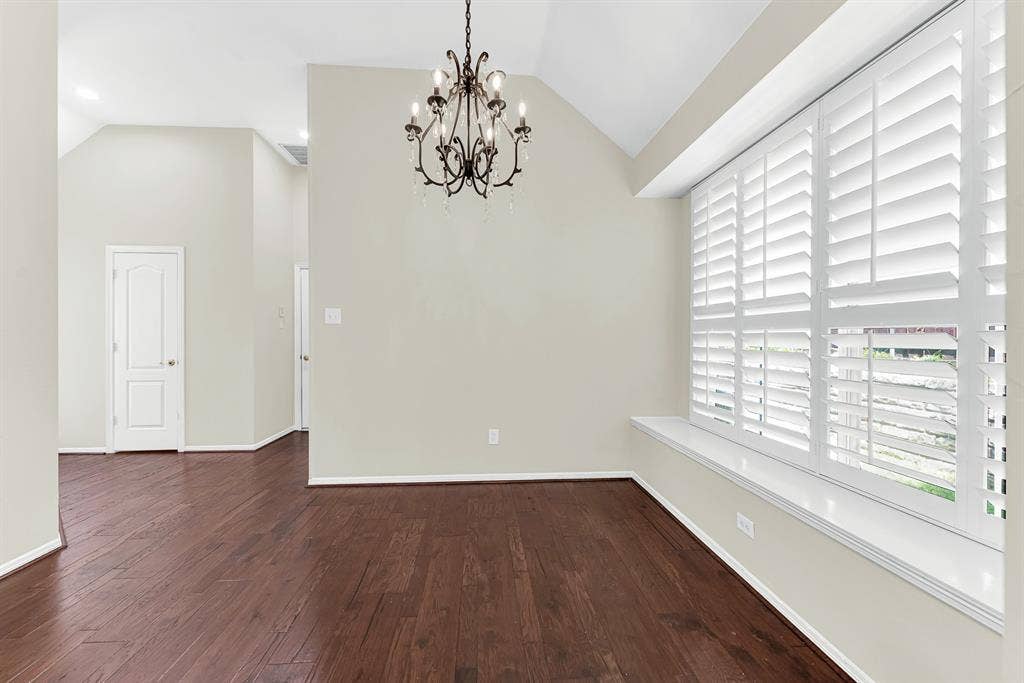 3217 Royal Melbourne Drive, Plano, TX 75093 Sunlight pours through wide plantation shutters onto a deep window bench and rich hardwood floors under a delicate chandelier. This charming nook is perfect for pulling up a table for casual morning breakfasts or relaxing with weekend coffee.