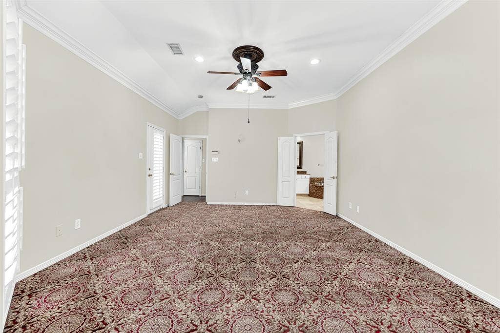 3217 Royal Melbourne Drive, Plano, TX 75093 Looking back across the room reveals double doors into the primary bathroom, clean neutral walls, and plenty of space for a full bedroom set. It offers a warm, quiet retreat designed for relaxed evenings and effortless daily routines.