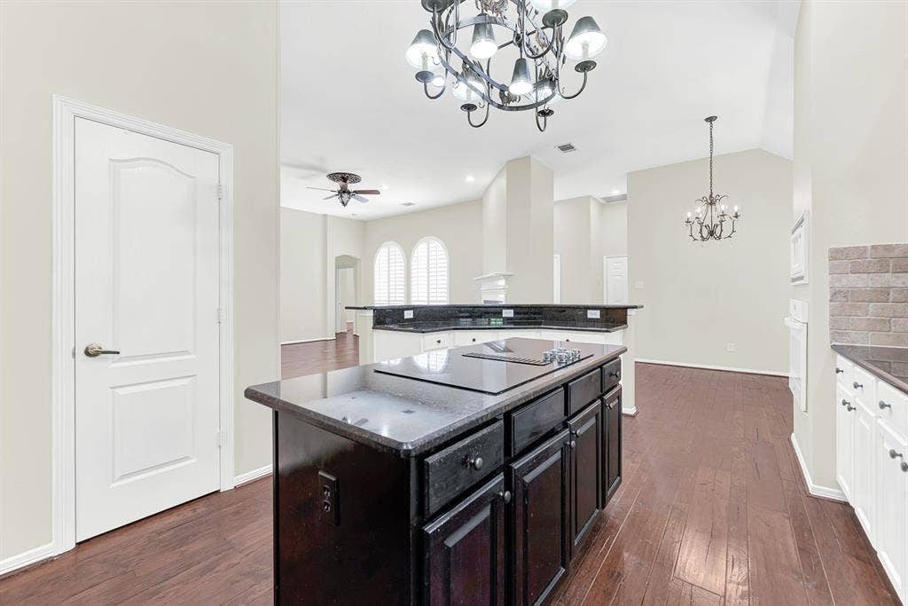 3217 Royal Melbourne Drive, Plano, TX 75093 Positioned by the pantry doorway, this view captures the seamless connection from the central island straight into the main living room and dining spaces. You can stay right in the middle of the fun while hosting parties or keeping an eye on everyday activities.
