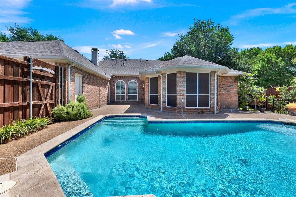 3217 Royal Melbourne Drive, Plano, TX 75093 A wide view reveals the full expanse of the pool area along with the patio space directly accessible from the home’s main living areas. It creates an inviting setting for effortless outdoor living, entertaining guests, and taking in sunny Texas days.