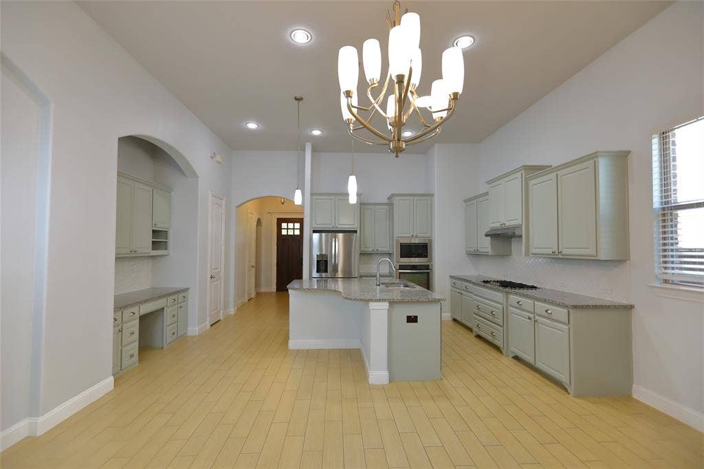 3707 Plum Vista Place, Arlington, TX 76005 Expansive kitchen and living area featuring wood-finish flooring, recessed lighting, and a contemporary chandelier