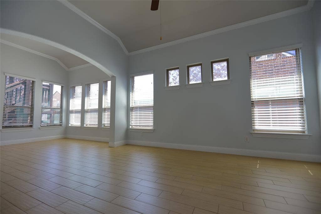 3707 Plum Vista Place, Arlington, TX 76005 Spacious interior with vaulted ceilings, light wood-finish flooring, and crown molding