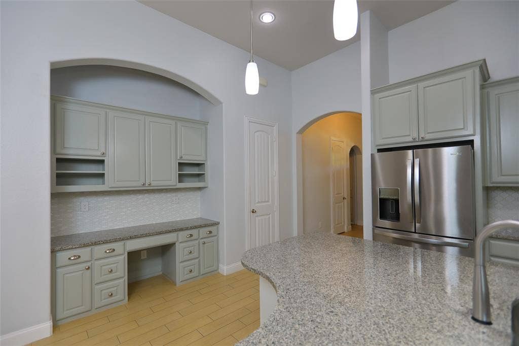 3707 Plum Vista Place, Arlington, TX 76005 Built-in desk area with light gray cabinetry, a mosaic tile backsplash, and a light-colored countertop