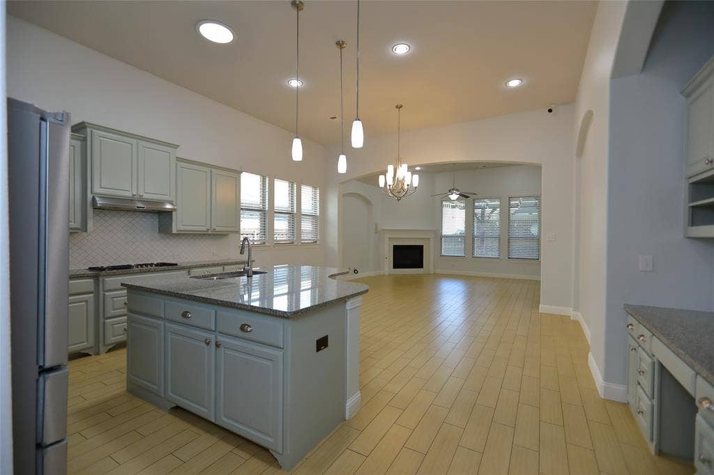 3707 Plum Vista Place, Arlington, TX 76005 Kitchen featuring light gray cabinetry, stainless steel appliances, and a central island with a sink