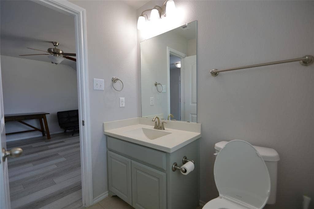 3707 Plum Vista Place, Arlington, TX 76005 Bathroom featuring a vanity with a light-colored countertop, an undermount sink, and brushed nickel fixtures