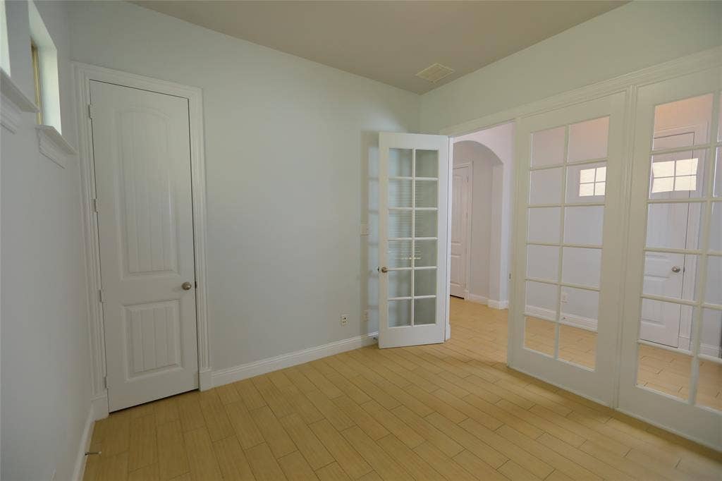 3707 Plum Vista Place, Arlington, TX 76005 Room featuring wood-finish flooring, light wall paint, and white trim
