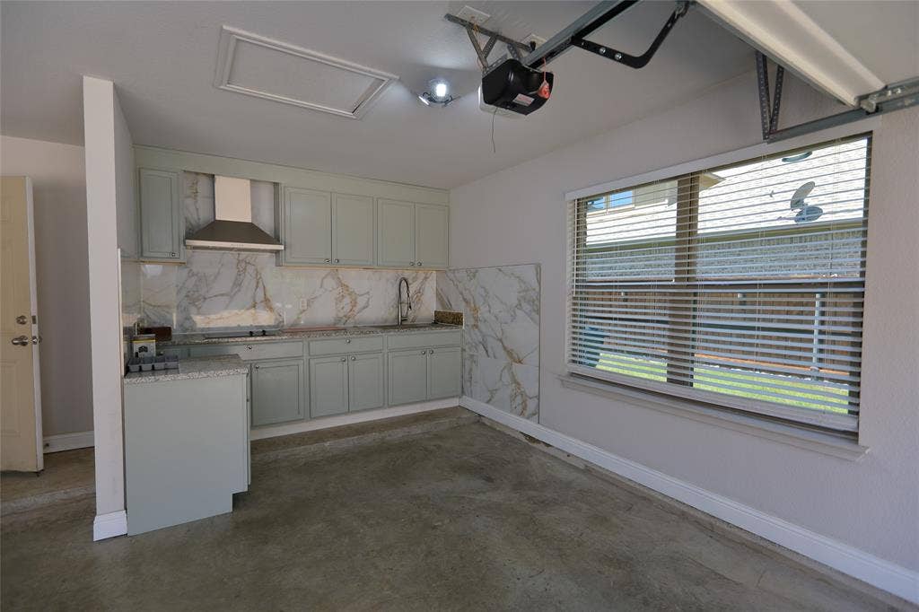 3707 Plum Vista Place, Arlington, TX 76005 Kitchenette featuring light gray cabinetry, a stainless steel range hood, stone slab backsplash, and a window with horizontal blinds