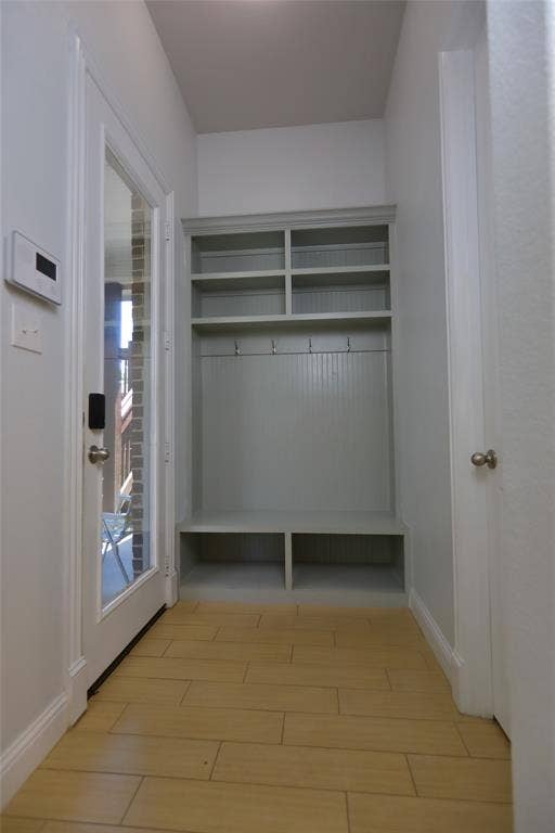 3707 Plum Vista Place, Arlington, TX 76005 Entryway featuring a built-in storage unit with upper shelving, coat hooks, and integrated bench seating