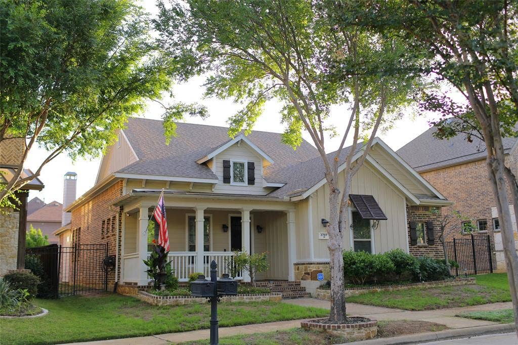 3707 Plum Vista Place, Arlington, TX 76005 Residential property featuring a covered front porch, brick and siding exterior, and mature trees