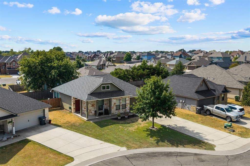 10313 Condor Loop, Waco, TX 76708 Pitched rooflines, partial stone facade, covered entry, and concrete driveway