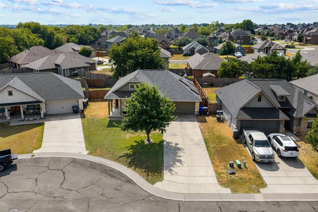 10313 Condor Loop, Waco, TX 76708 Cul-de-sac property featuring a gabled roofline, attached two-car garage, and an extra long concrete driveway