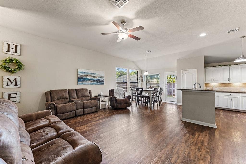 10313 Condor Loop, Waco, TX 76708 Open-concept living space featuring wood-finish flooring, vaulted ceilings, and recessed lighting