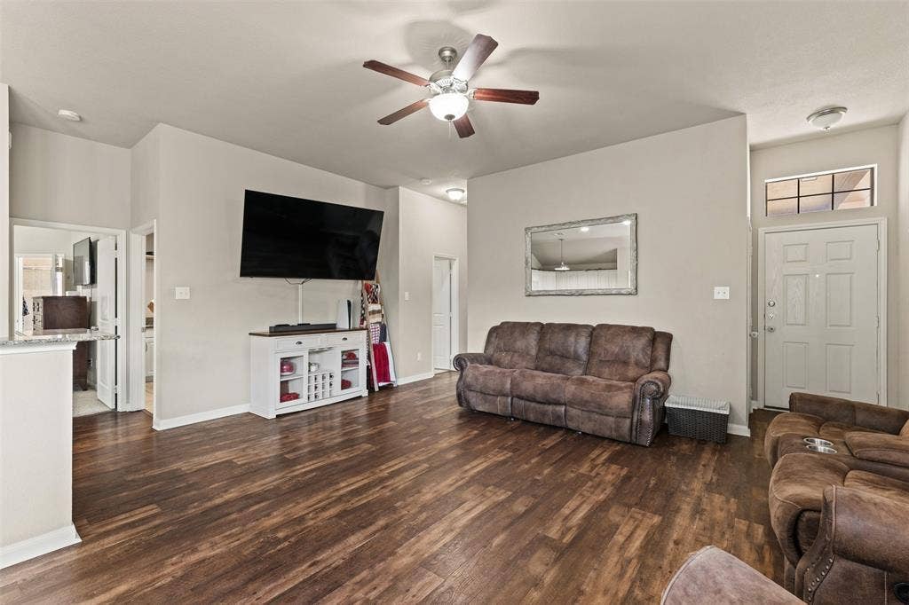 10313 Condor Loop, Waco, TX 76708 Wood-finish flooring throughout, ceiling fan with integrated lighting, and a front entry door with transom window