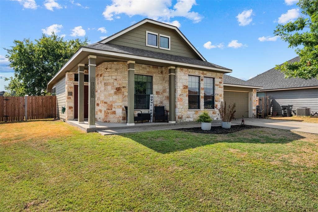 10313 Condor Loop, Waco, TX 76708 Stone and siding exterior with a covered front porch featuring architectural columns, an attached garage, and a fenced backyard