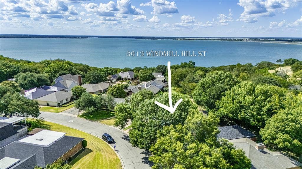3613 Windmill Hill Street, Waco, TX 76710 Aerial perspective of this waterfront property on Normandy Hill Street, showcasing mature landscaping, manicured lawn, and direct water access with expansive bay vistas
