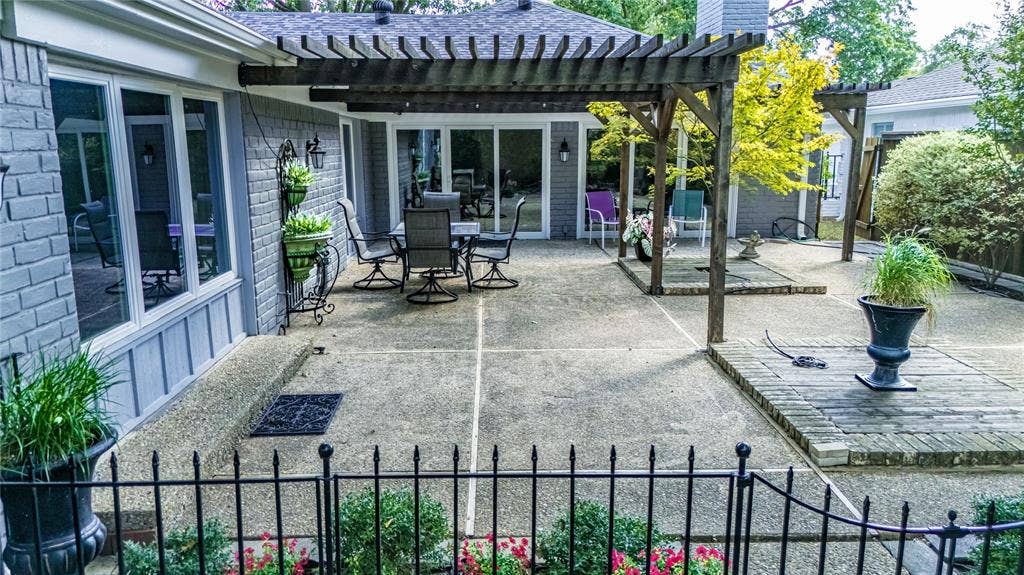 3613 Windmill Hill Street, Waco, TX 76710 Expansive concrete patio featuring a wood pergola and brick paver accents