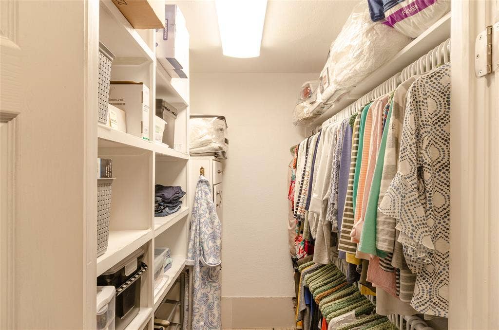 3613 Windmill Hill Street, Waco, TX 76710 Custom built-in shelving, white wall paint, flush mount lighting, hard surface flooring, and a white door frame