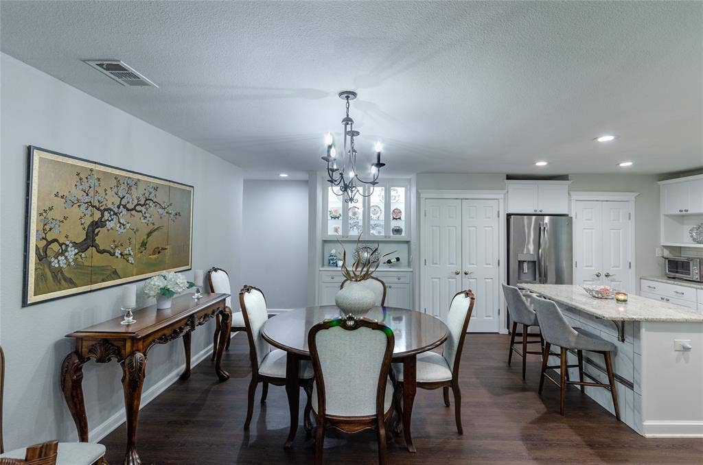 3613 Windmill Hill Street, Waco, TX 76710 Open-concept dining area with wood-finish flooring, a built-in display cabinet, and recessed lighting