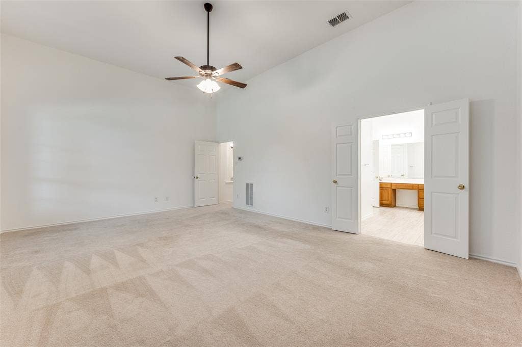 Another view of the massive primary bedroom, with double doors to the expansive primary bathroom.  This area includes a huge walk-in closet.
