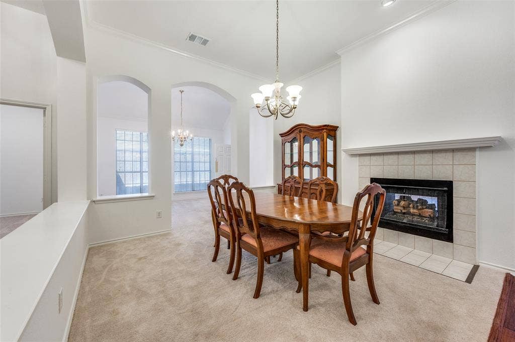 Double-sided fireplace with a mantel, arched doorways, and a chandelier.  This space could serve as your reading room, where you can nestle in, relax, and enjoy the tranquil setting.