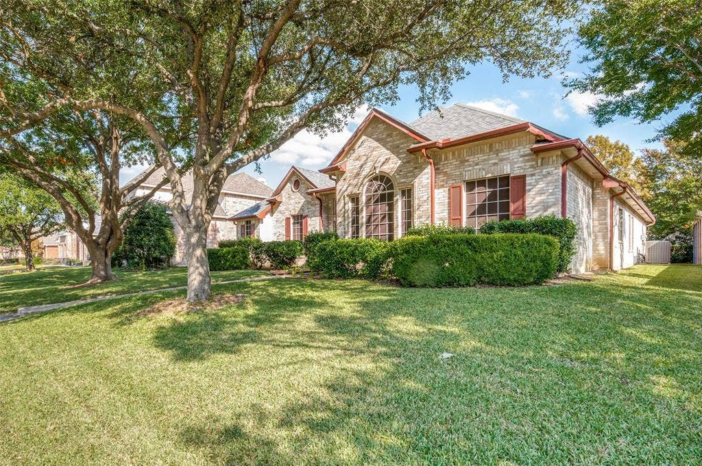 Another view of this nicely landscaped front elevation of this beautiful home. Two majestic oak trees shade the home's front.