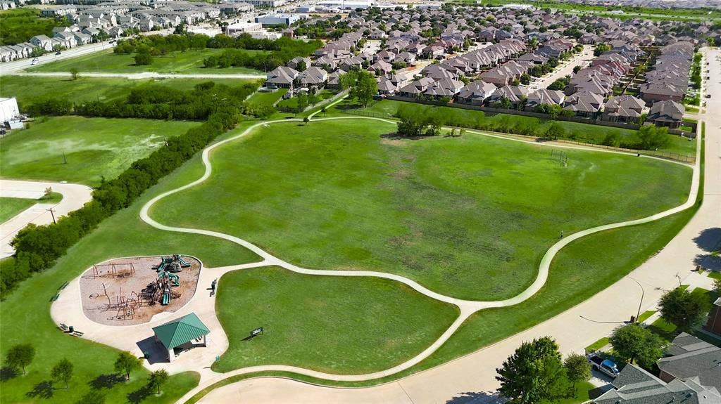 9812 Nolina Road, Fort Worth, TX 76177 Expansive green space featuring meandering paved pathways, a dedicated playground area, and a covered gazebo
