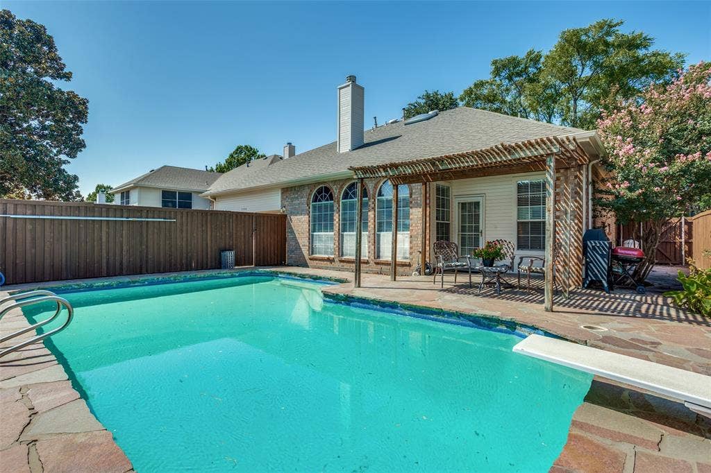 4308 Cedar Valley Drive, Plano, TX 75024 pool and covered patio with side space used for gardening supplies.