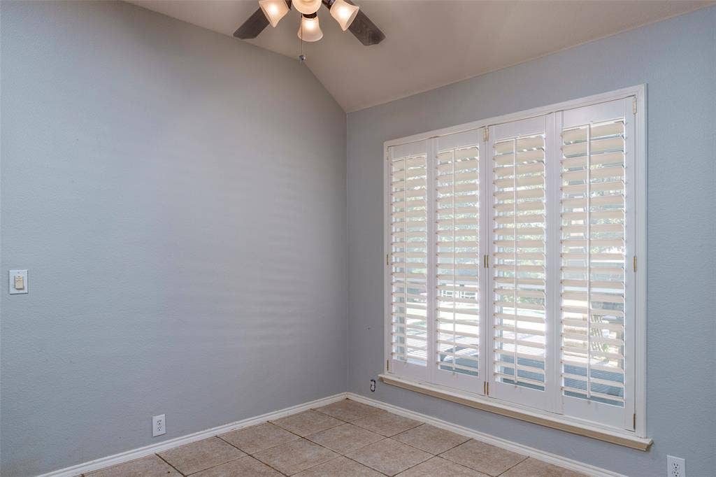 1620 Babbling Brook Drive, Grand Prairie, TX 75050 Vaulted ceiling with a ceiling fan, white plantation shutters, and light-toned flooring