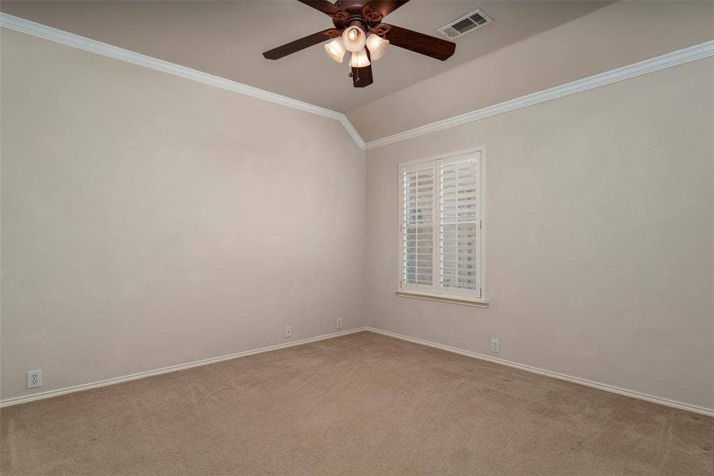 1620 Babbling Brook Drive, Grand Prairie, TX 75050 Vaulted ceiling with crown molding, ceiling fan, neutral carpet, and window with plantation shutters
