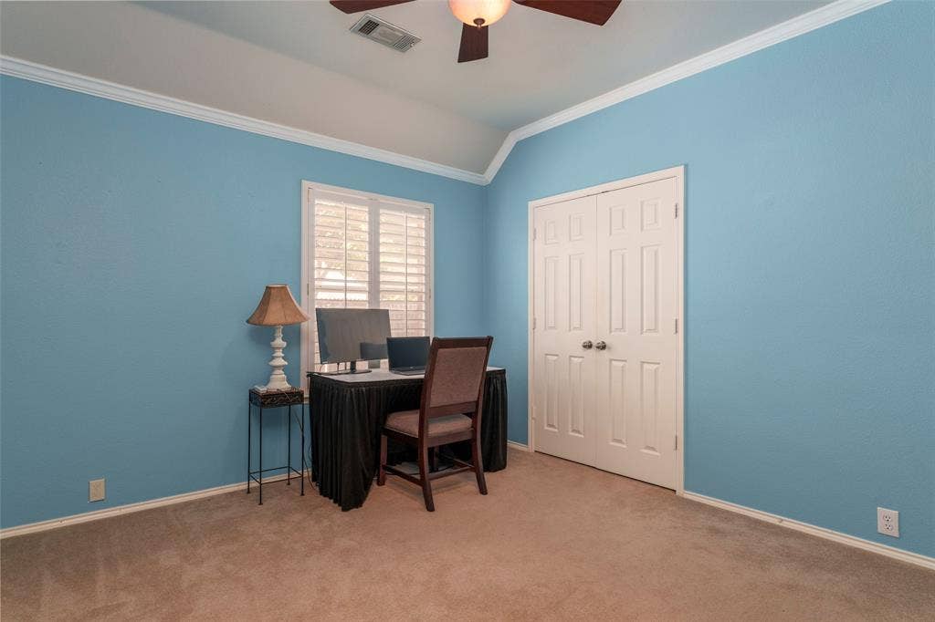 1620 Babbling Brook Drive, Grand Prairie, TX 75050 Recessed window with white plantation shutters, white crown molding, vaulted ceiling, and carpeted flooring