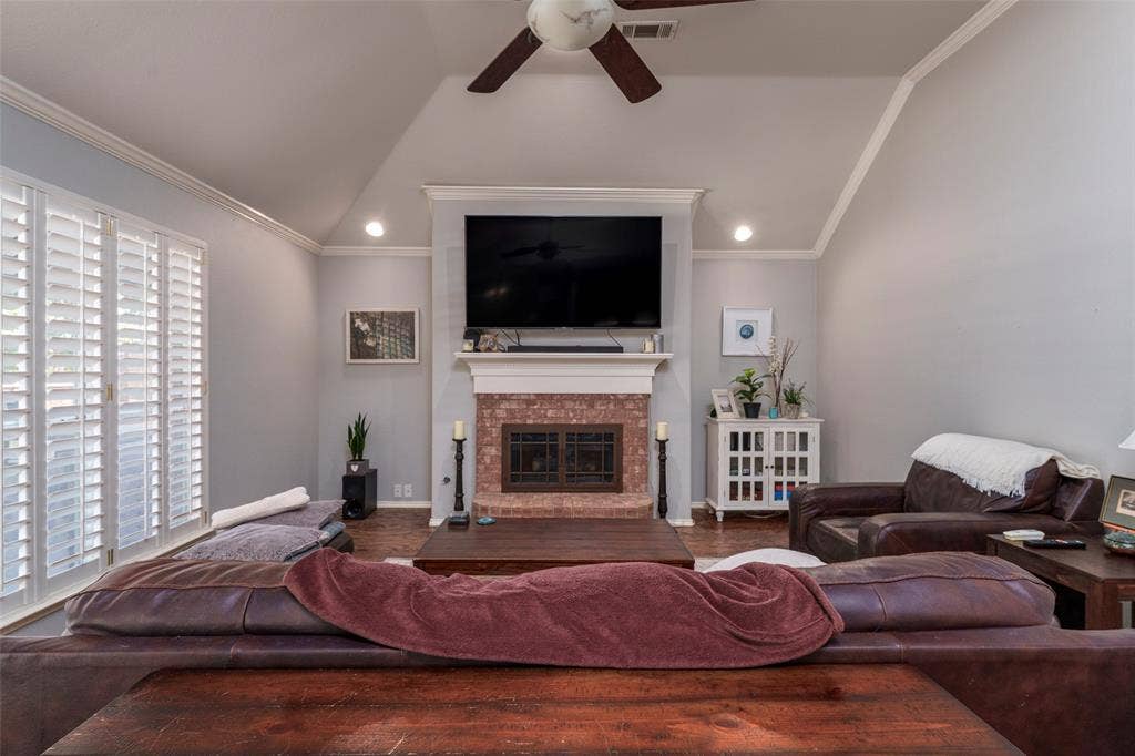1620 Babbling Brook Drive, Grand Prairie, TX 75050 Living area featuring a brick fireplace with a white mantel, high vaulted ceilings, recessed lighting, and wood-finish flooring