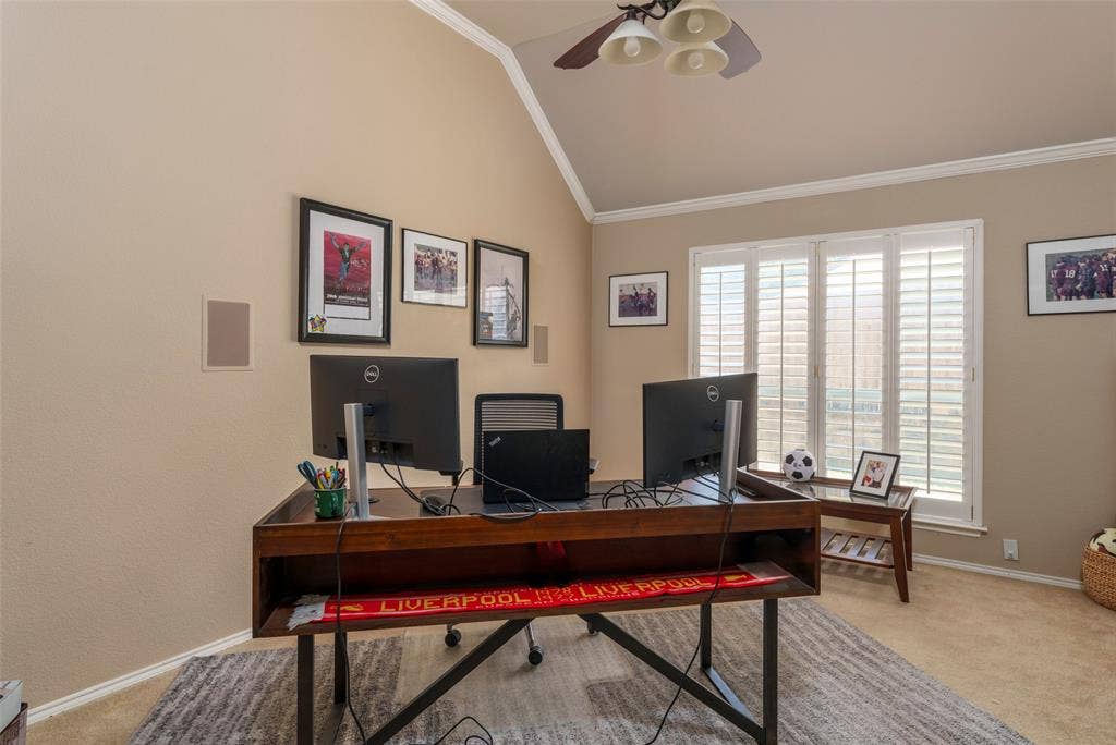 1620 Babbling Brook Drive, Grand Prairie, TX 75050 Vaulted ceiling with crown molding, ceiling fan with integrated lighting, built-in wall speakers, and plantation shutters on multiple windows