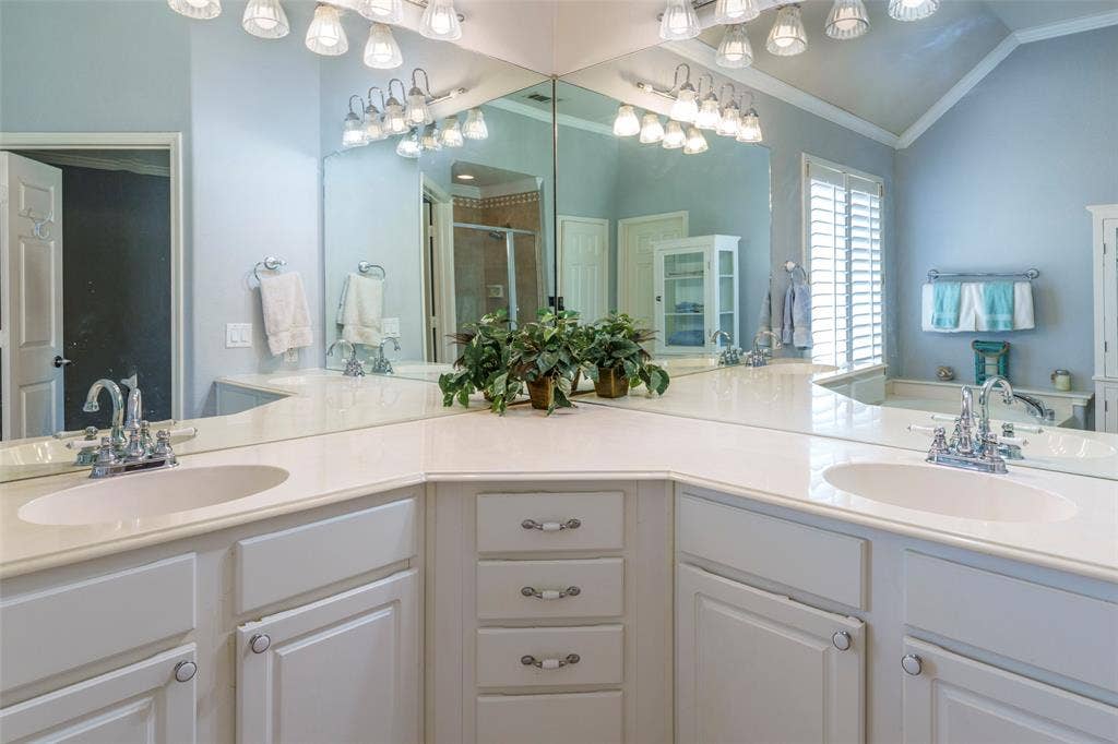 1620 Babbling Brook Drive, Grand Prairie, TX 75050 Dual vanity with white cabinetry, light-colored countertops, and chrome fixtures